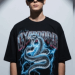 Unleash your inner power with the Men’s Black “CYBORG” Oversized Snake Graphic T-Shirt, designed for bold streetwear enthusiasts. Featuring a striking cyber-serpent coiled in lightning and futuristic “CYBORG” typography, this tee makes an electrifying statement. Crafted from premium cotton in an oversized fit, it's perfect for those who live life on the edge of fashion and technology. Key Features: High-impact cyber snake graphic with electric blue lightning effect “CYBORG” metallic-style text for a futuristic street vibe Relaxed, oversized fit for comfort and trend-forward style Durable cotton fabric that feels soft and breathable Ideal for concerts, nightlife, urban streetwear, and casual daily wear