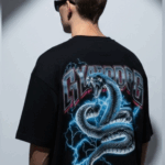 Unleash your inner power with the Men’s Black “CYBORG” Oversized Snake Graphic T-Shirt, designed for bold streetwear enthusiasts. Featuring a striking cyber-serpent coiled in lightning and futuristic “CYBORG” typography, this tee makes an electrifying statement. Crafted from premium cotton in an oversized fit, it's perfect for those who live life on the edge of fashion and technology. Key Features: High-impact cyber snake graphic with electric blue lightning effect “CYBORG” metallic-style text for a futuristic street vibe Relaxed, oversized fit for comfort and trend-forward style Durable cotton fabric that feels soft and breathable Ideal for concerts, nightlife, urban streetwear, and casual daily wear