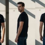 Male model wearing a black t-shirt with "پاکستانی" written in white Urdu script. He is sitting against a concrete wall, posing confidently with a calm expression.